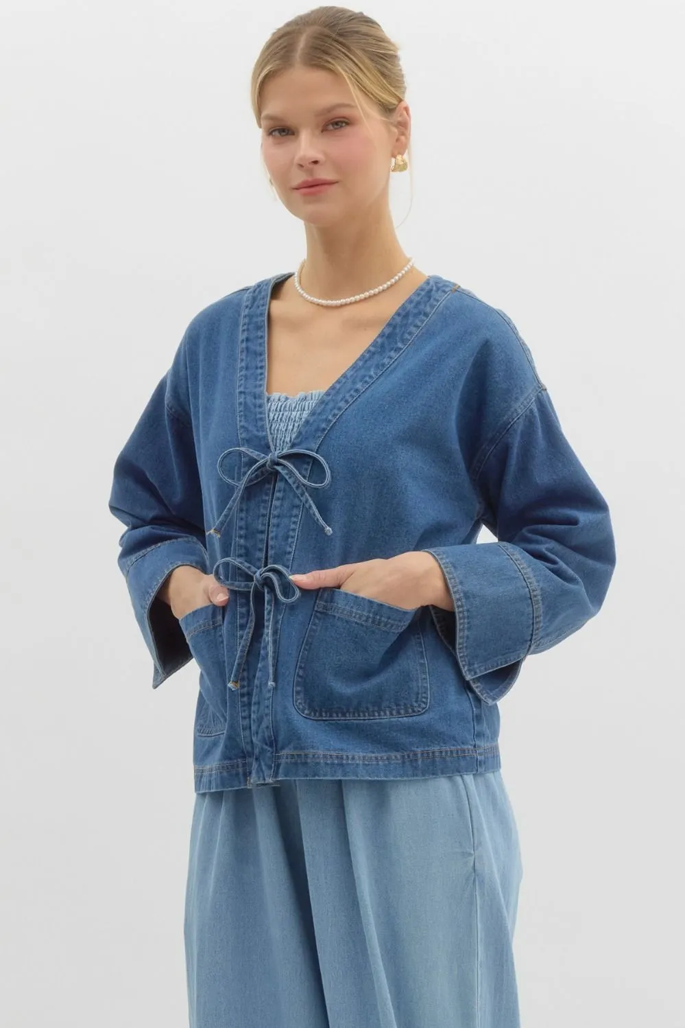 Denim jacket featuring front bow tie